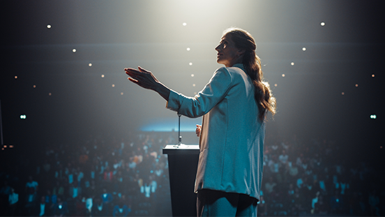 A modern, hybrid business event setup with a mix of in-person and virtual attendees, showcasing AI-driven matchmaking or XR presentations.